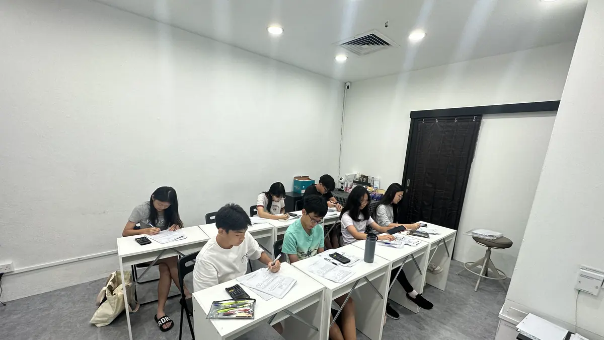 A Math Vigilante class in progress: seven secondary students working through a paper at their desks